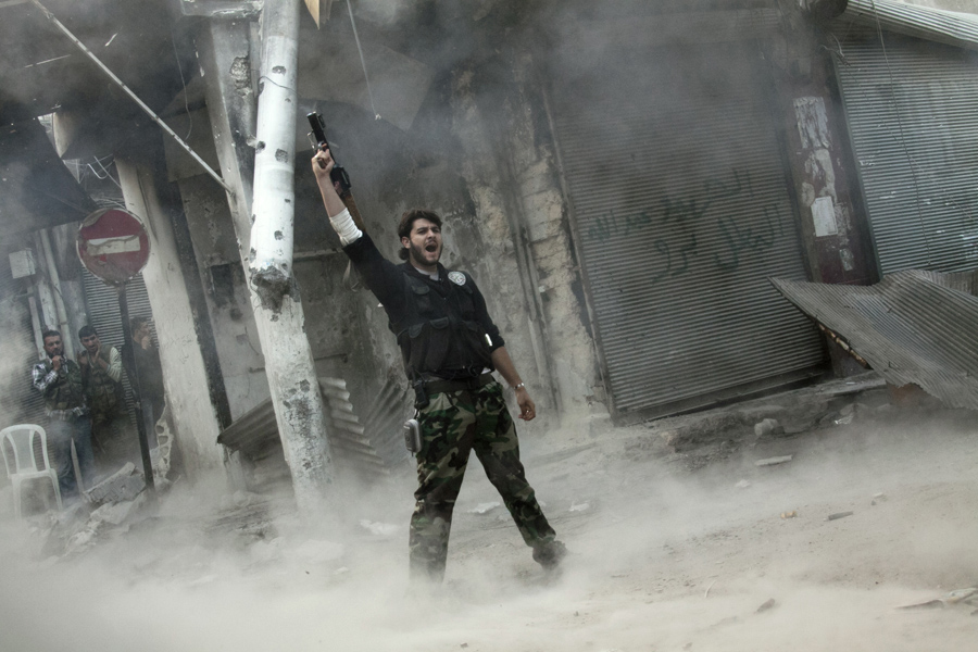 Narciso Contreras Pulitzer-winning photo: A rebel fighter gestures for victory after firing a shoulder-fired missile toward a building where Syrian troops loyal to President Bashar Assad were hiding as they attempted to gain terrain against the rebels during heavy clashes in the Jedida district of Aleppo, Syria, Nov. 4, 2012.    